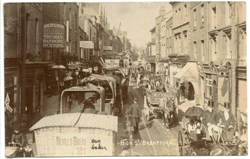 A view of the congested roadway with a tram, tradesmen's carts and some carriages. In the foreground a note 'our baker' has been added to a 'Nevill's Bread' cart