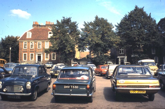 Colour photo showing cars parked in front of Georgian building