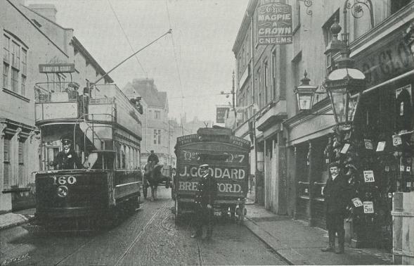 Street scene with open-top tram and Goddard's cart filling most of road width