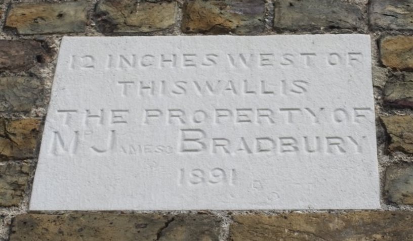 Plaque: 12 inches west of this wall is the property of Mr James Bradbury 1891