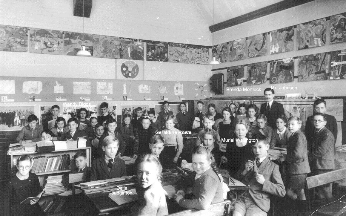 Classroom scene, nearly 40 pupils and their form teacher