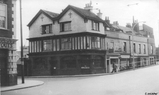 Black & white photo of  corner pub and view beyond