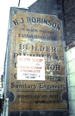 Painted advertising sign for H J Robinson on the side of a property